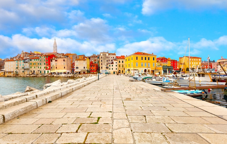 View of colorful buildings from a stone pier