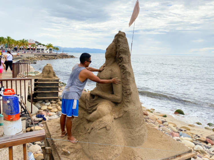 An artist, making sand sculpture on the Malecon of Puerto Vallarta