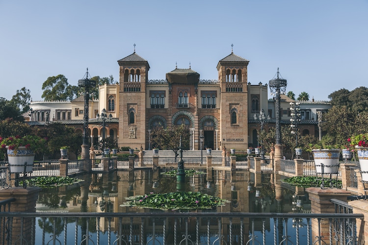 A building of a Museum in front of pond in Seville