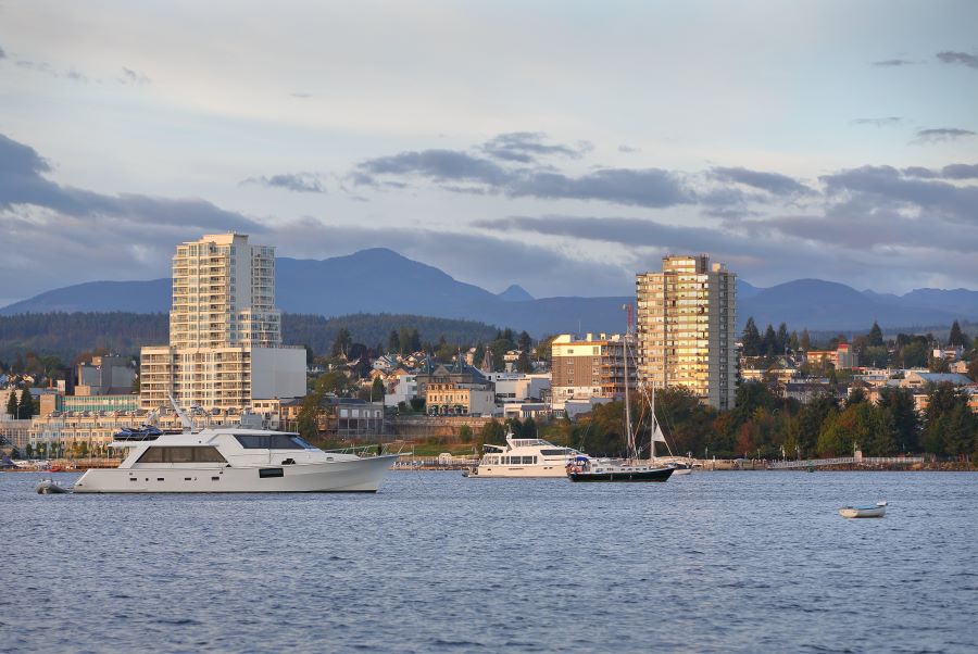 Boats in the water near Nanaimo's harborfront, with the city skyline visible in the background