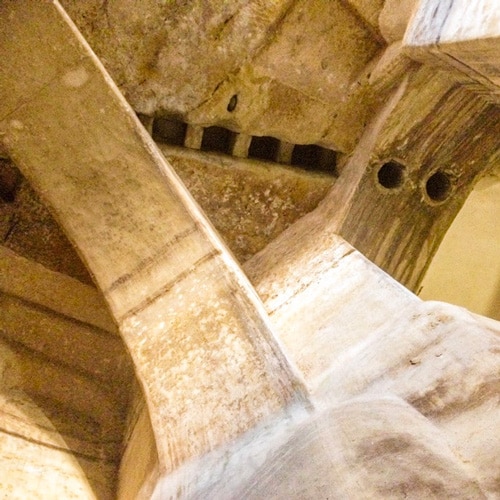 Holes in stone ceiling for fetching water in Matera old buildings