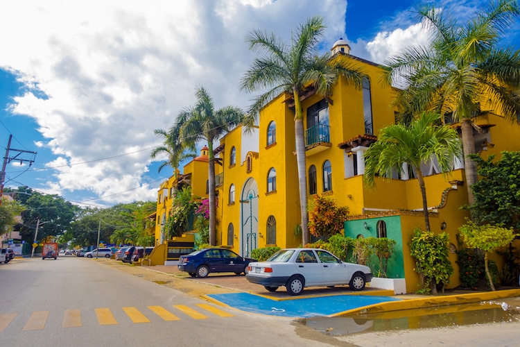 Bright yellow buildings with palm trees