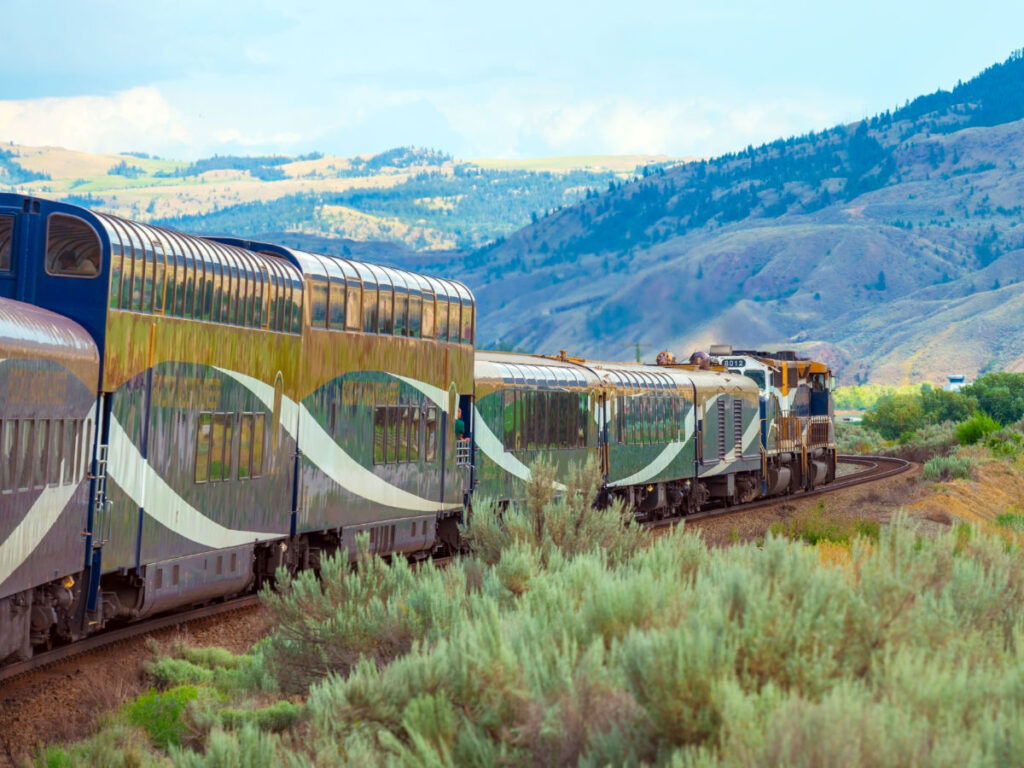 Luxury train wagons passing through scenic Kamloops, BC