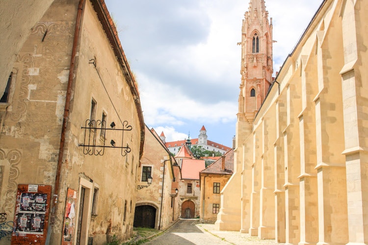 Pale beige buildings with a church steeple