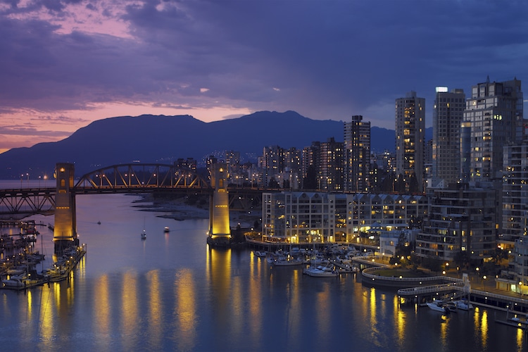 View of Yaletown and the Burrard Bridge in False Creek in the city of Vancouver at night