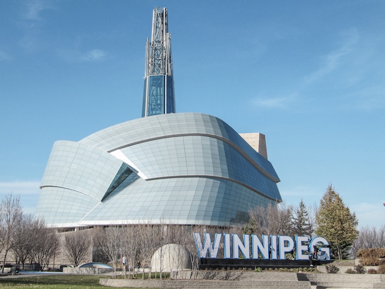 The Canadian Human Rights Museum with a "Winnipeg" sign in front of it in downtown Winnipeg, Manitoba