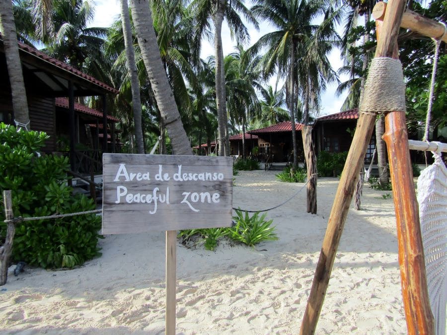 A sign that reads "peaceful zone" on Xcalacoco beach