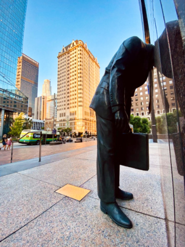 A statue of a businessman who got in over his head on the window